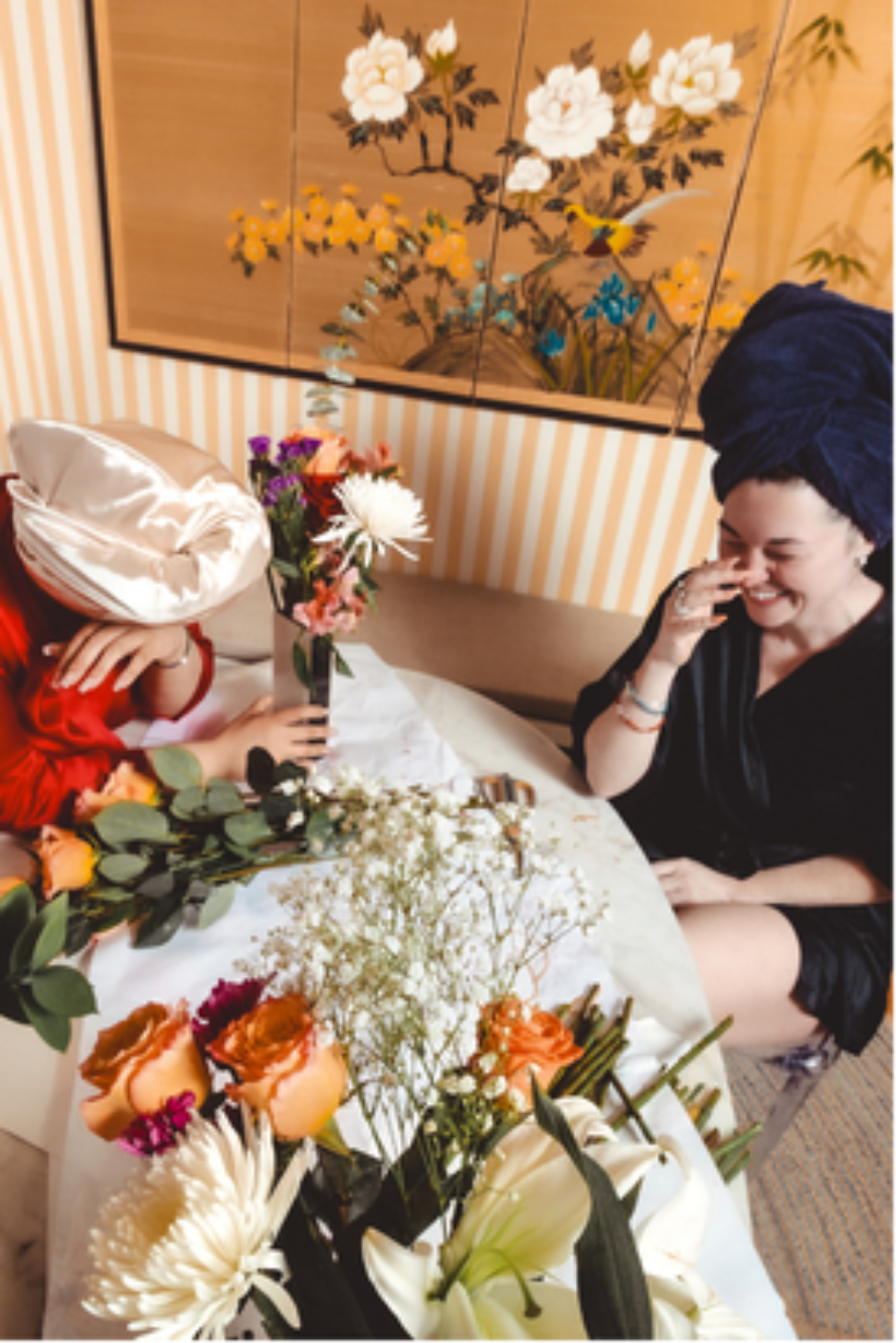 Bernie and Anabelle laugh together at the kitchen table. Bernie Sinclaire describes the Mommune as a woman-centered and child-centered alternative family structure. |LaniLee@lanileephotography. Used with permission.